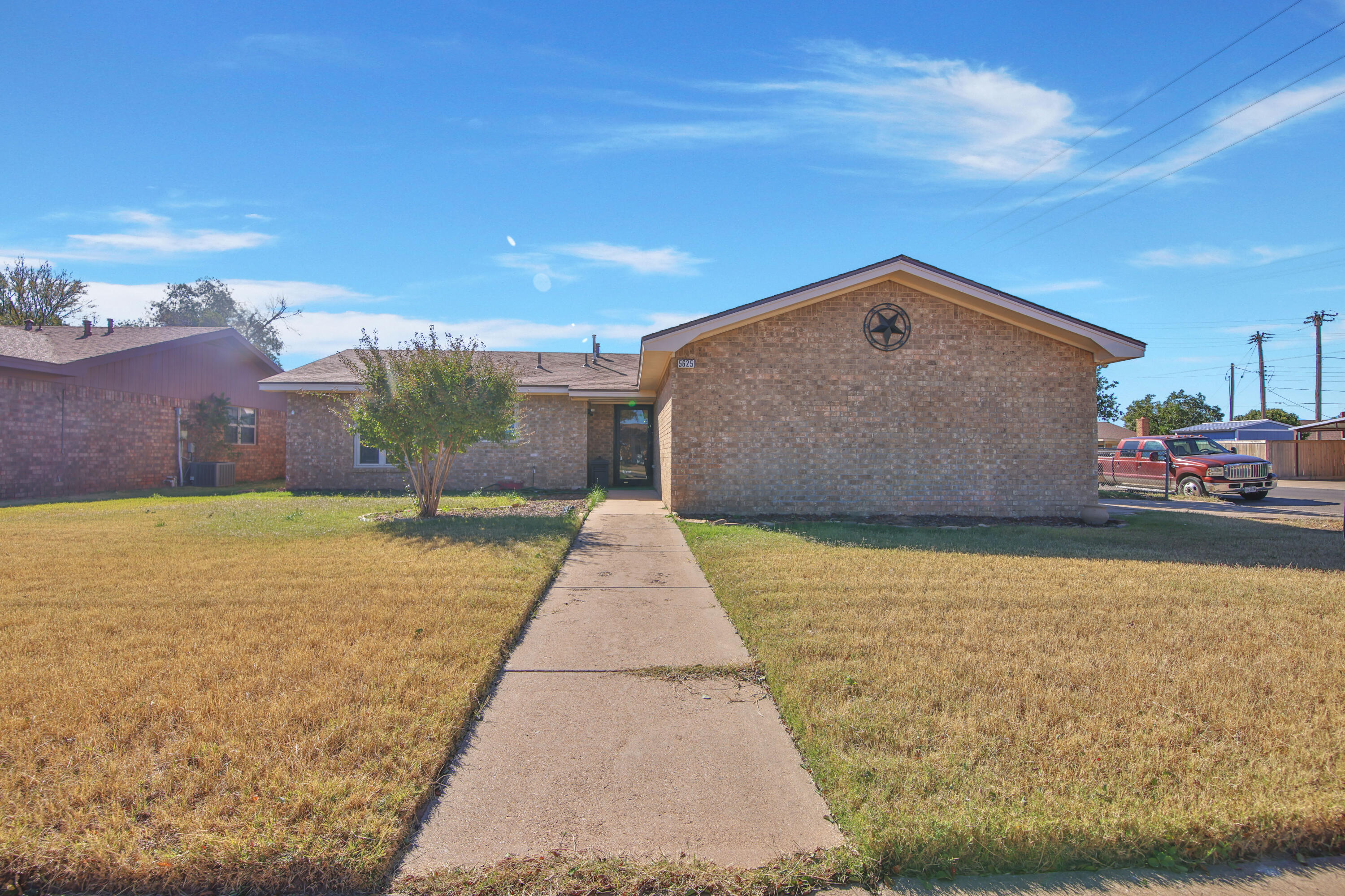 5625 Amherst Street Lubbock, TX 79416 - Photo 2 of 32 a front view of a house with a yard