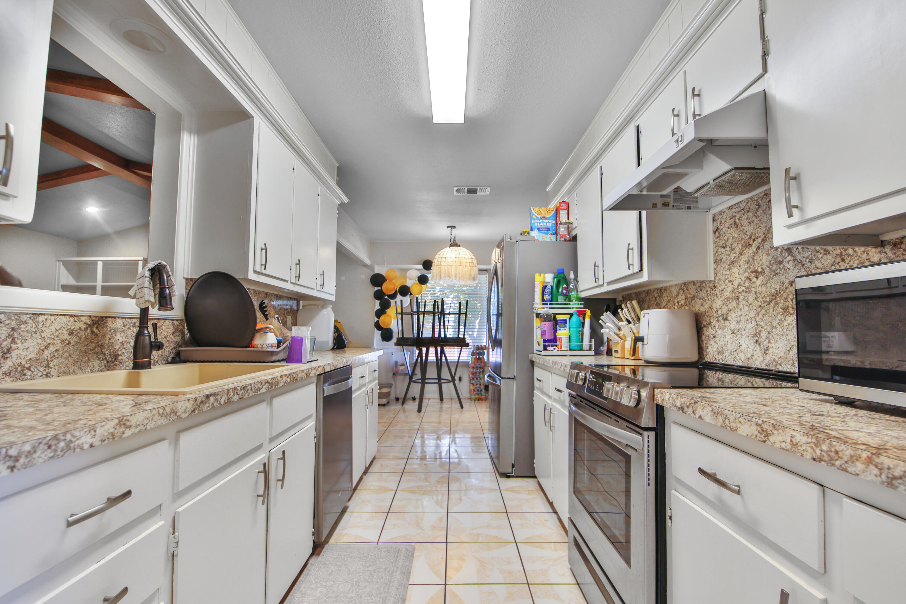 5625 Amherst Street Lubbock, TX 79416 - Photo 6 of 32 a kitchen with stainless steel appliances granite countertop a stove and cabinets