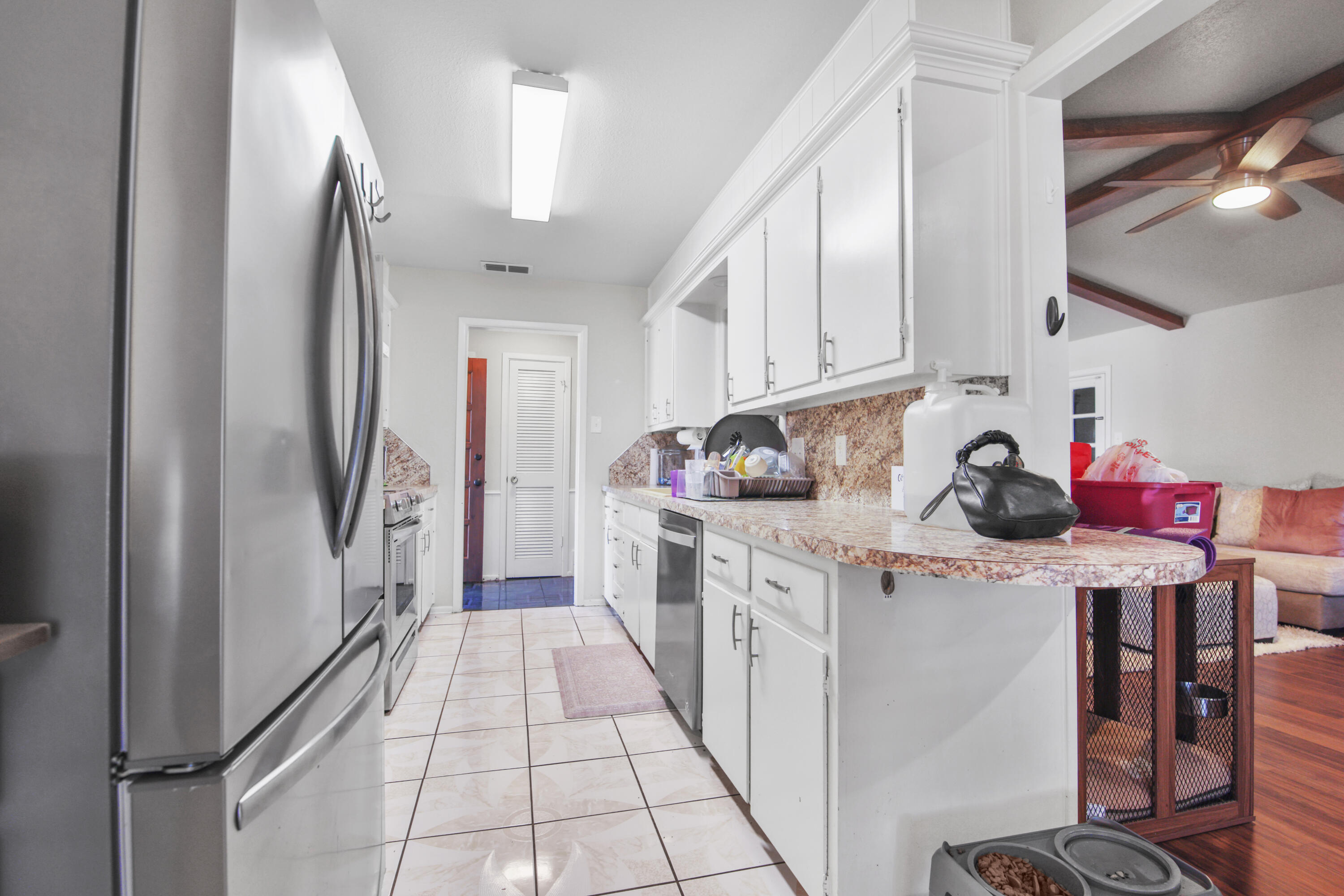 5625 Amherst Street Lubbock, TX 79416 - Photo 8 of 32 a kitchen with stainless steel appliances granite countertop a refrigerator and a stove
