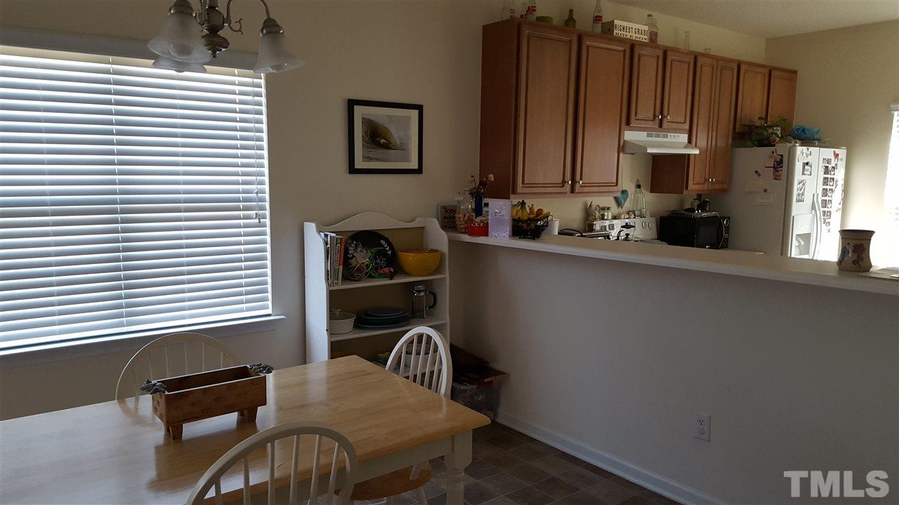 4806 Kitledge Drive Raleigh, NC 27610 - Photo 11 of 24 a view of a chair and table in a kitchen