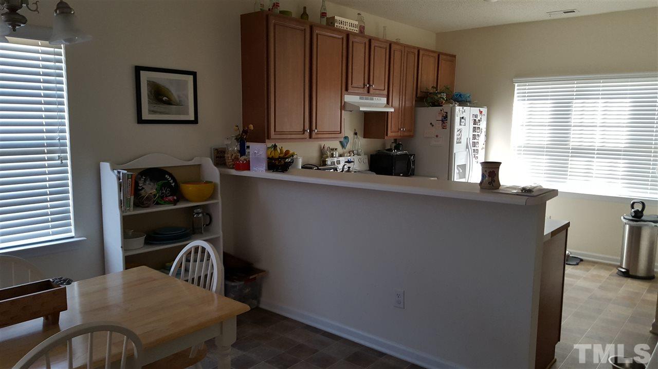 4806 Kitledge Drive Raleigh, NC 27610 - Photo 12 of 24 a kitchen with granite countertop a refrigerator a stove a sink and dishwasher