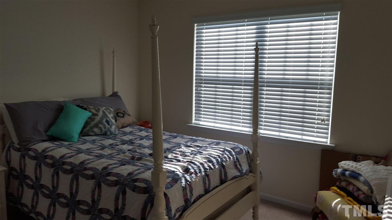 4806 Kitledge Drive Raleigh, NC 27610 - Photo 18 of 24 a bedroom with a bed and a window