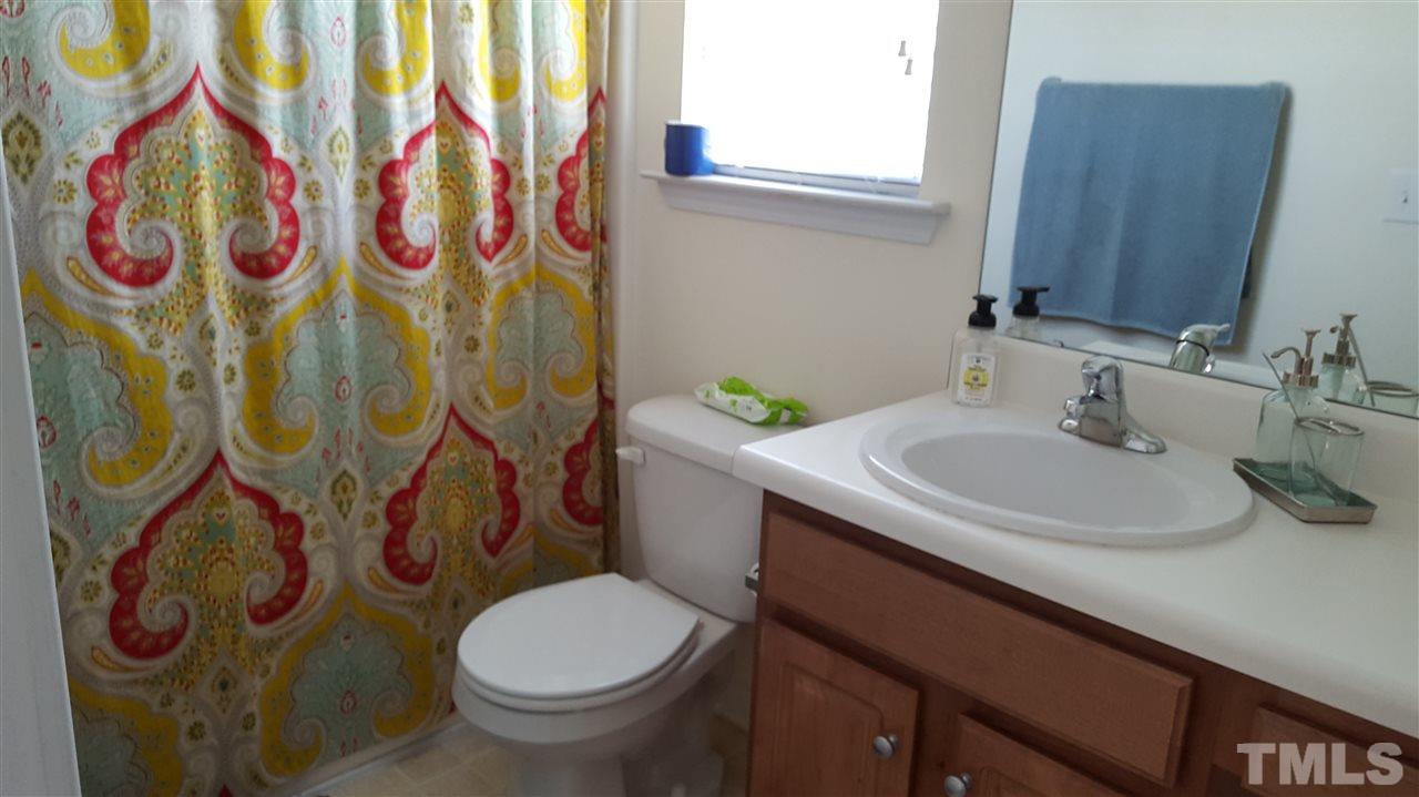 4806 Kitledge Drive Raleigh, NC 27610 - Photo 19 of 24 a bathroom with a sink and a toilet
