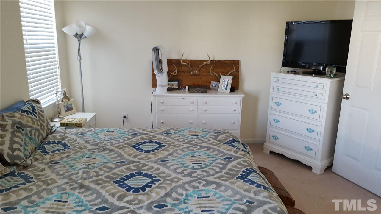 4806 Kitledge Drive Raleigh, NC 27610 - Photo 20 of 24 a bedroom with a bed and flat screen tv