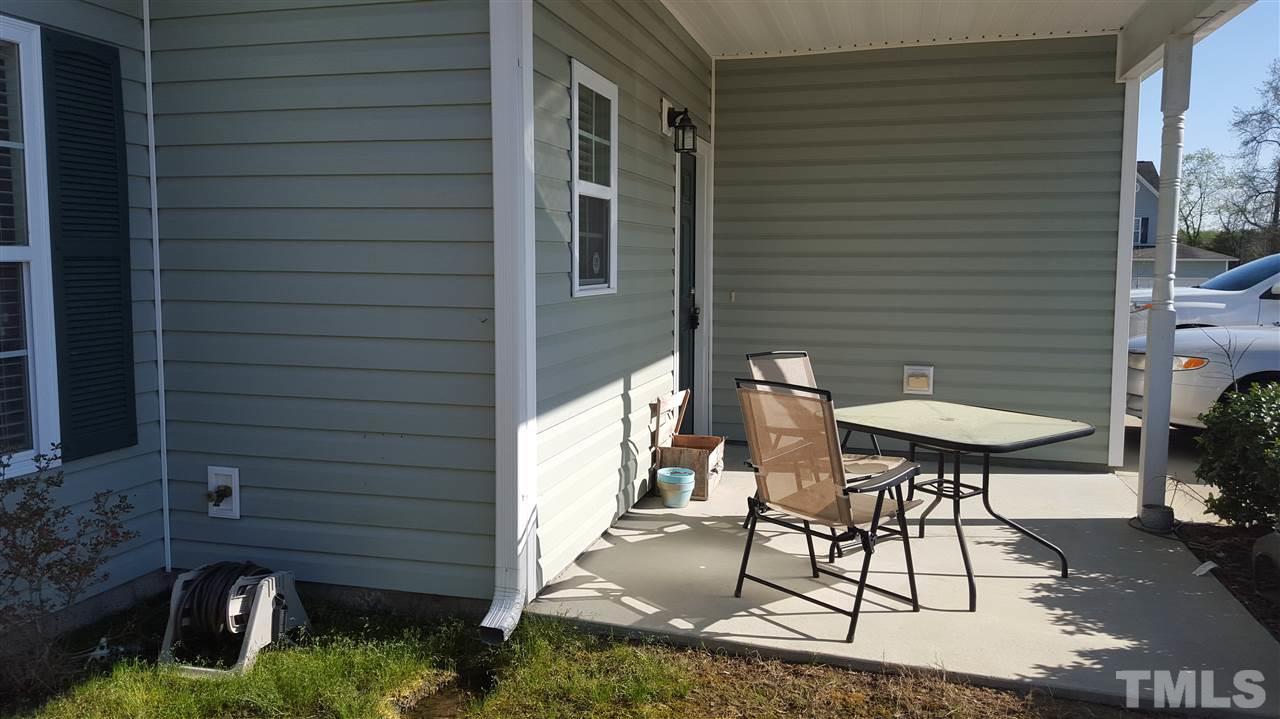 4806 Kitledge Drive Raleigh, NC 27610 - Photo 3 of 24 a backyard of a house with table and chairs