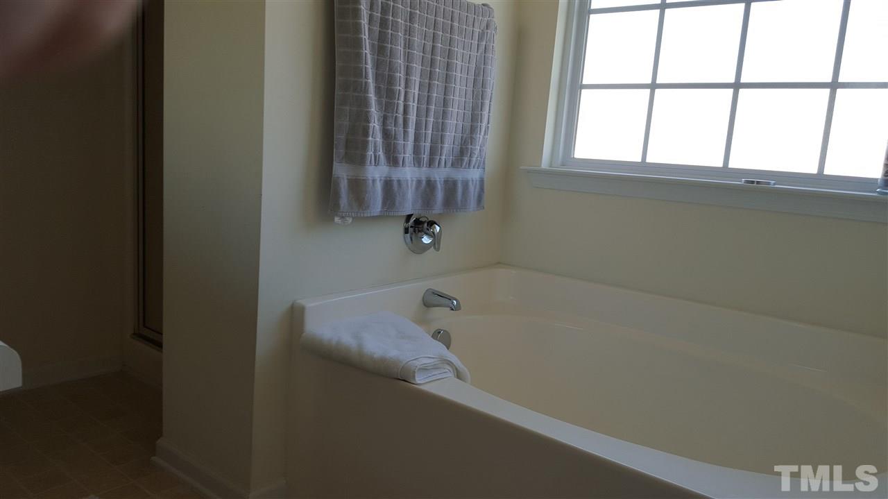 4806 Kitledge Drive Raleigh, NC 27610 - Photo 22 of 24 a bath tub sitting next to a window