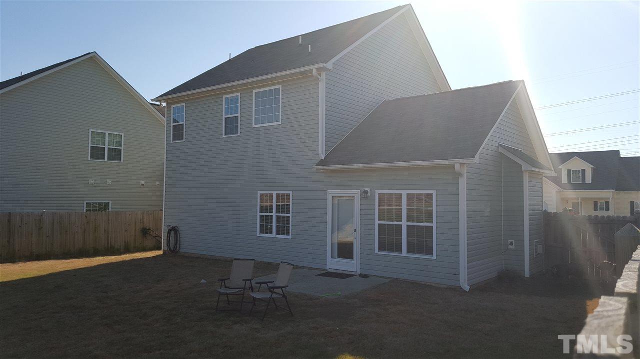 4806 Kitledge Drive Raleigh, NC 27610 - Photo 24 of 24 a backyard of a house with table and chairs