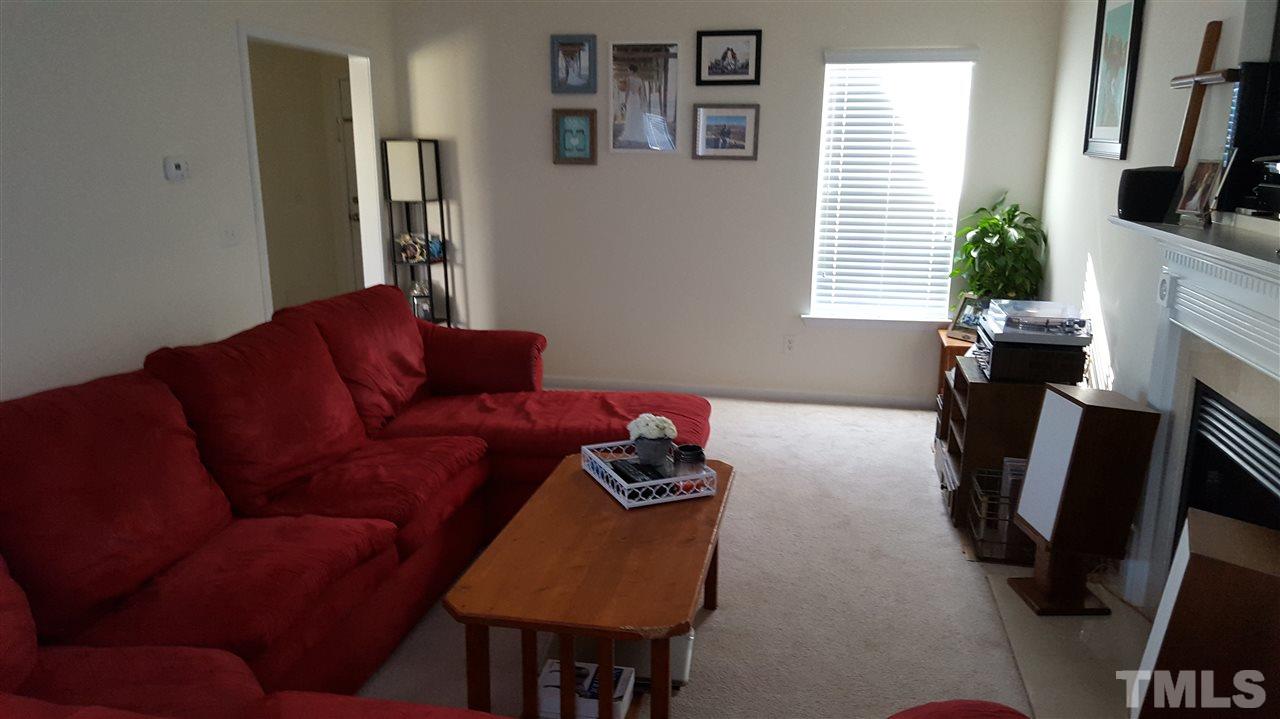 4806 Kitledge Drive Raleigh, NC 27610 - Photo 5 of 24 a living room with furniture and a flat screen tv