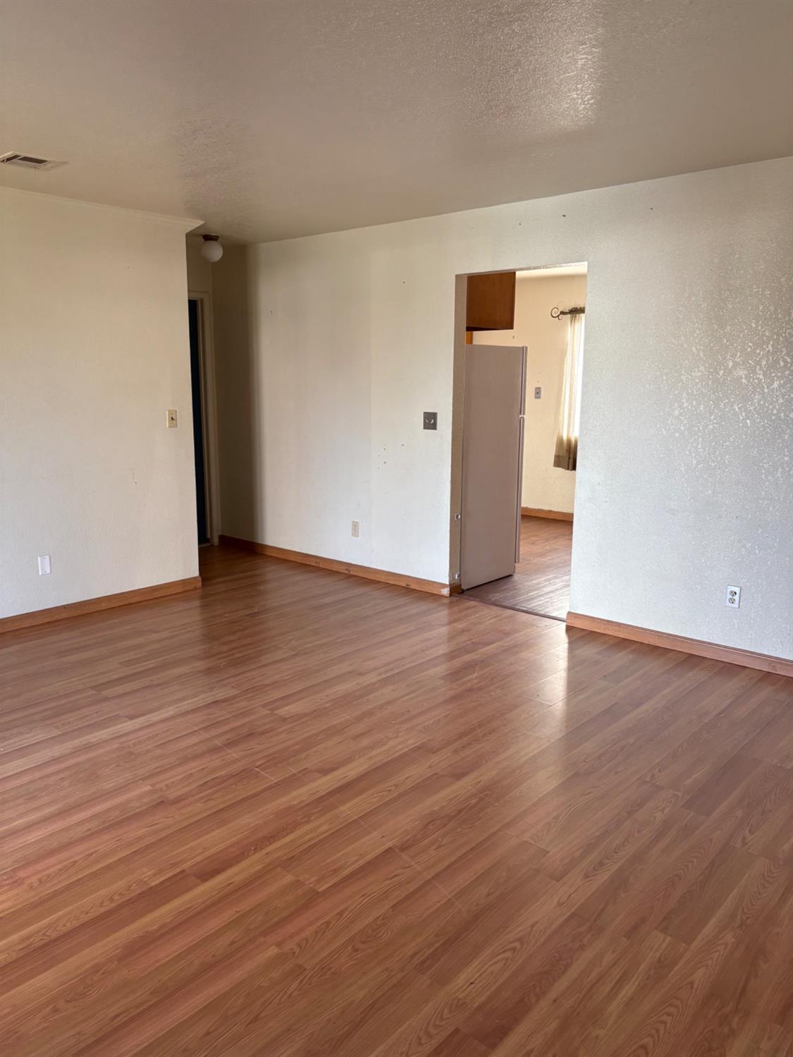 206 West 12th Street Tracy, CA 95376 - Photo 12 of 17 a view of an empty room with wooden floor and closet