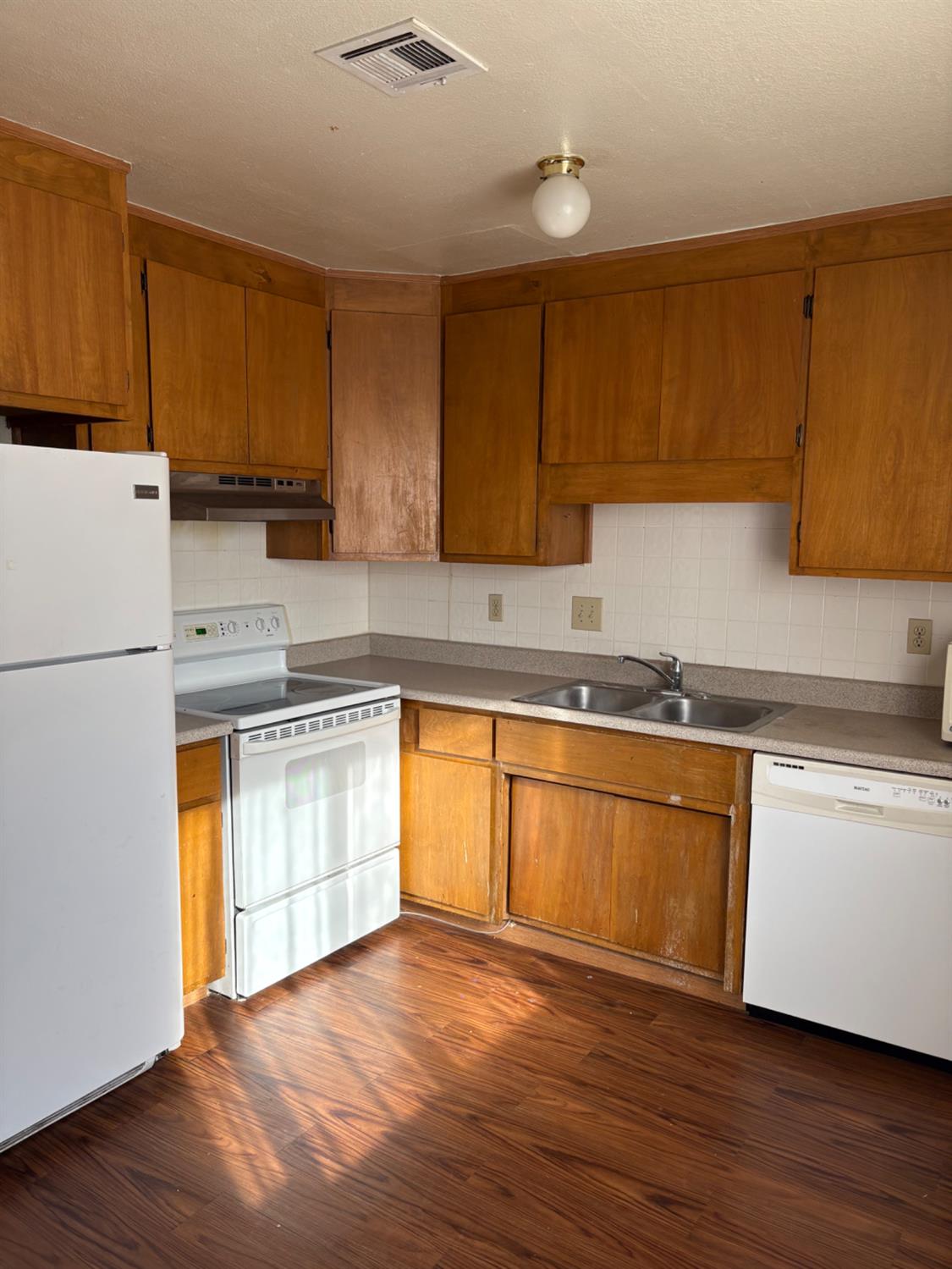 206 West 12th Street Tracy, CA 95376 - Photo 13 of 17 a kitchen with granite countertop wooden cabinets stainless steel appliances and a counter space