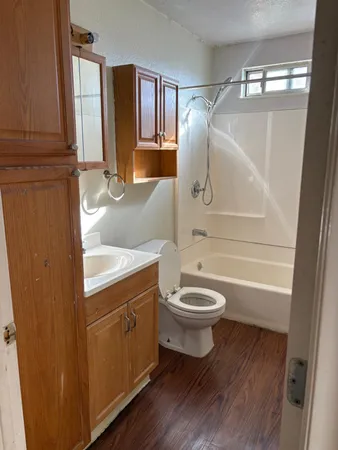 a bathroom with a toilet a sink and bathtub