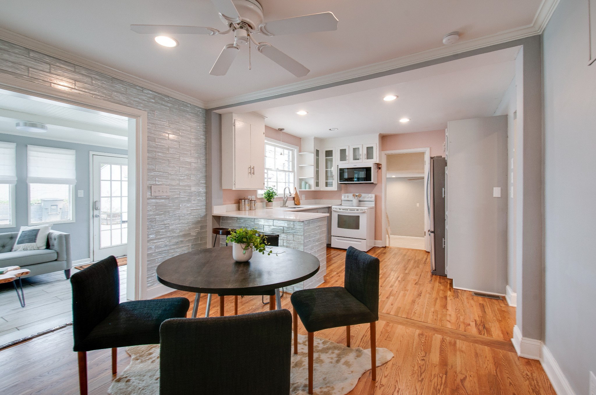 918 Mitchell Road Nashville, TN 37206 - Photo 10 of 34 a kitchen with stainless steel appliances kitchen island granite countertop a dining table chairs and a refrigerator
