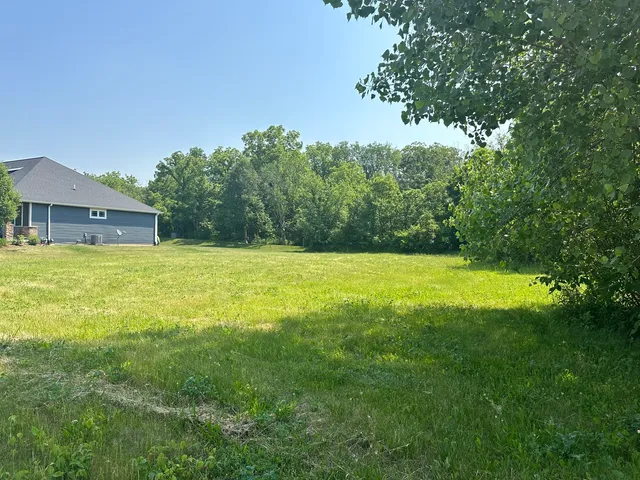 a view of a swimming pool with a yard