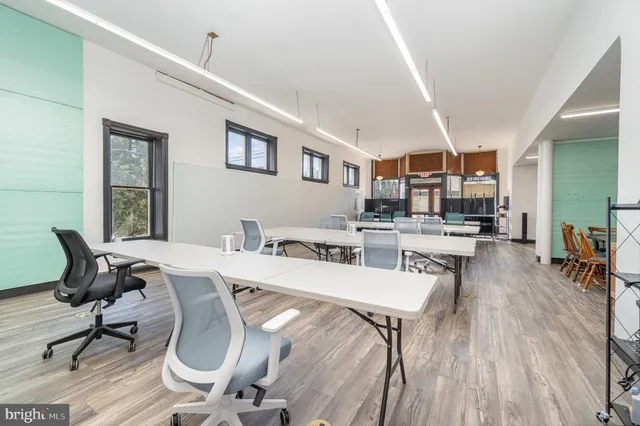 a living room with furniture a wooden floor and next to a window