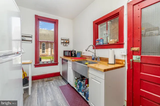 a kitchen with a stove a sink and a window