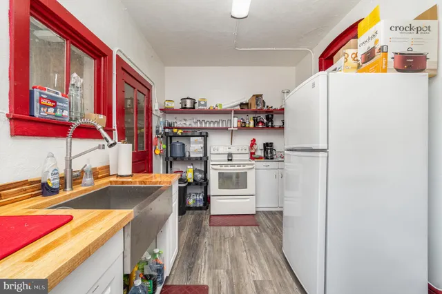 a kitchen with stainless steel appliances a refrigerator and a stove