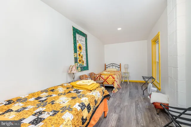 a bed sitting in a bedroom next to a window