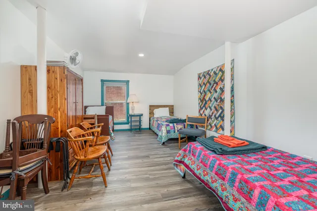 a bedroom with furniture and wooden floor