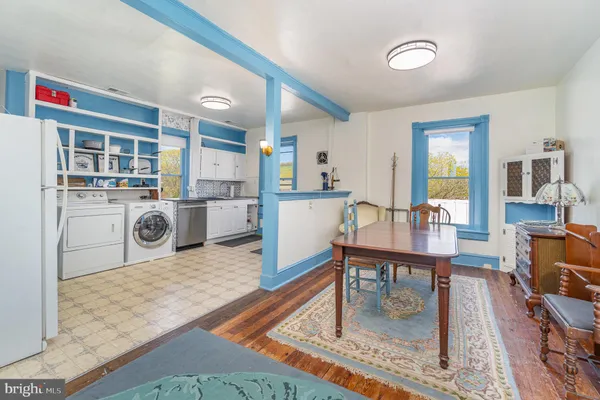 a kitchen with furniture wooden floor and a fireplace