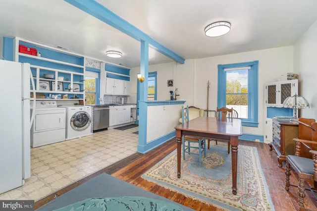 a kitchen with furniture wooden floor and a fireplace