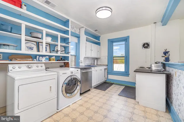 a kitchen with a stove top oven and cabinets
