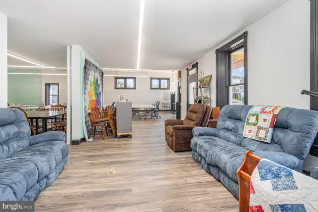a living room with furniture and large windows
