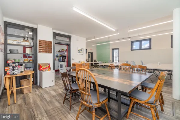 a view of a dining room and livingroom with furniture wooden floor and a rug