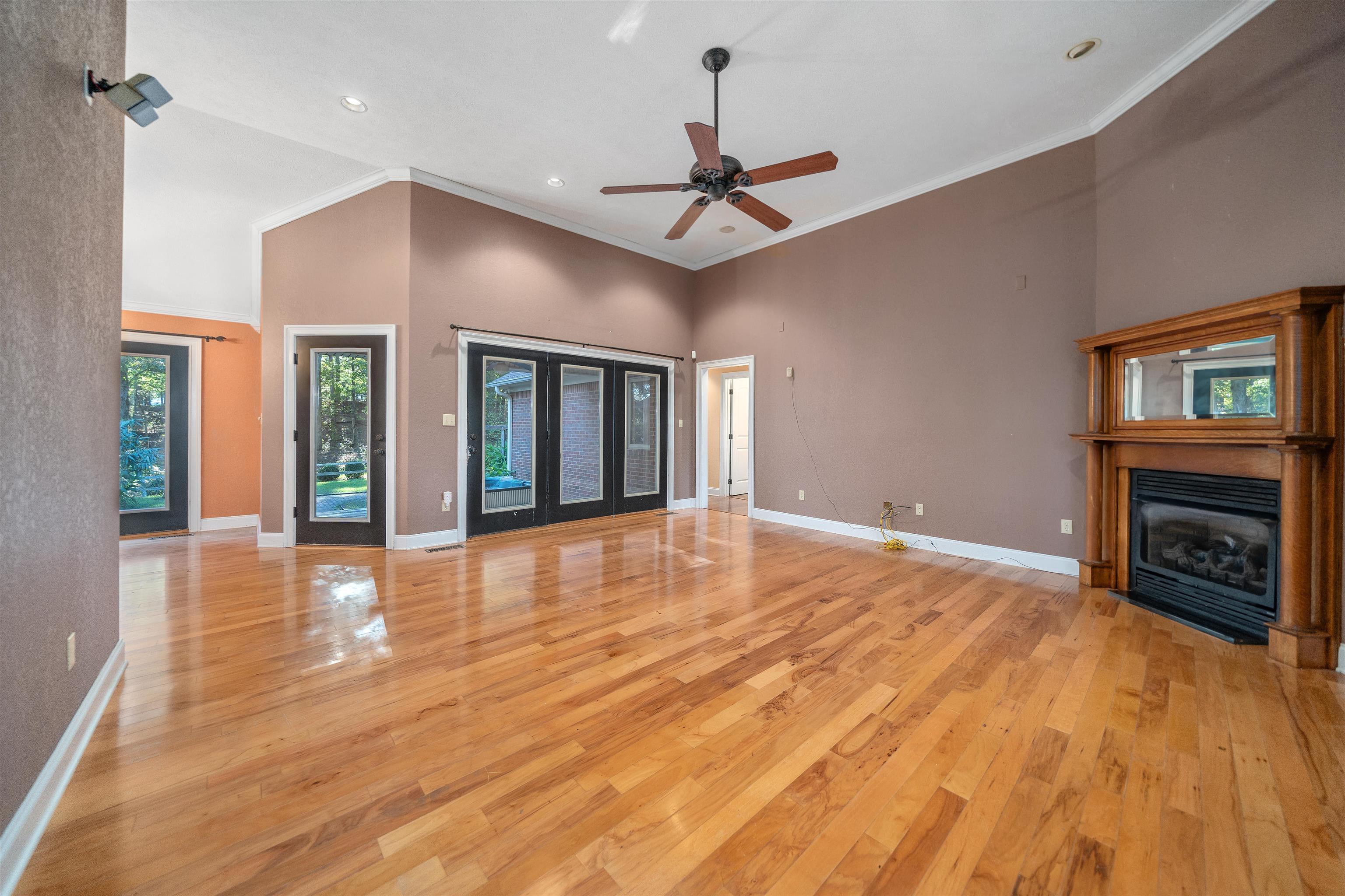 31 Timber Lane Selmer, TN 38375 - Photo 16 of 29 a view of an empty room with wooden floor fireplace and a window