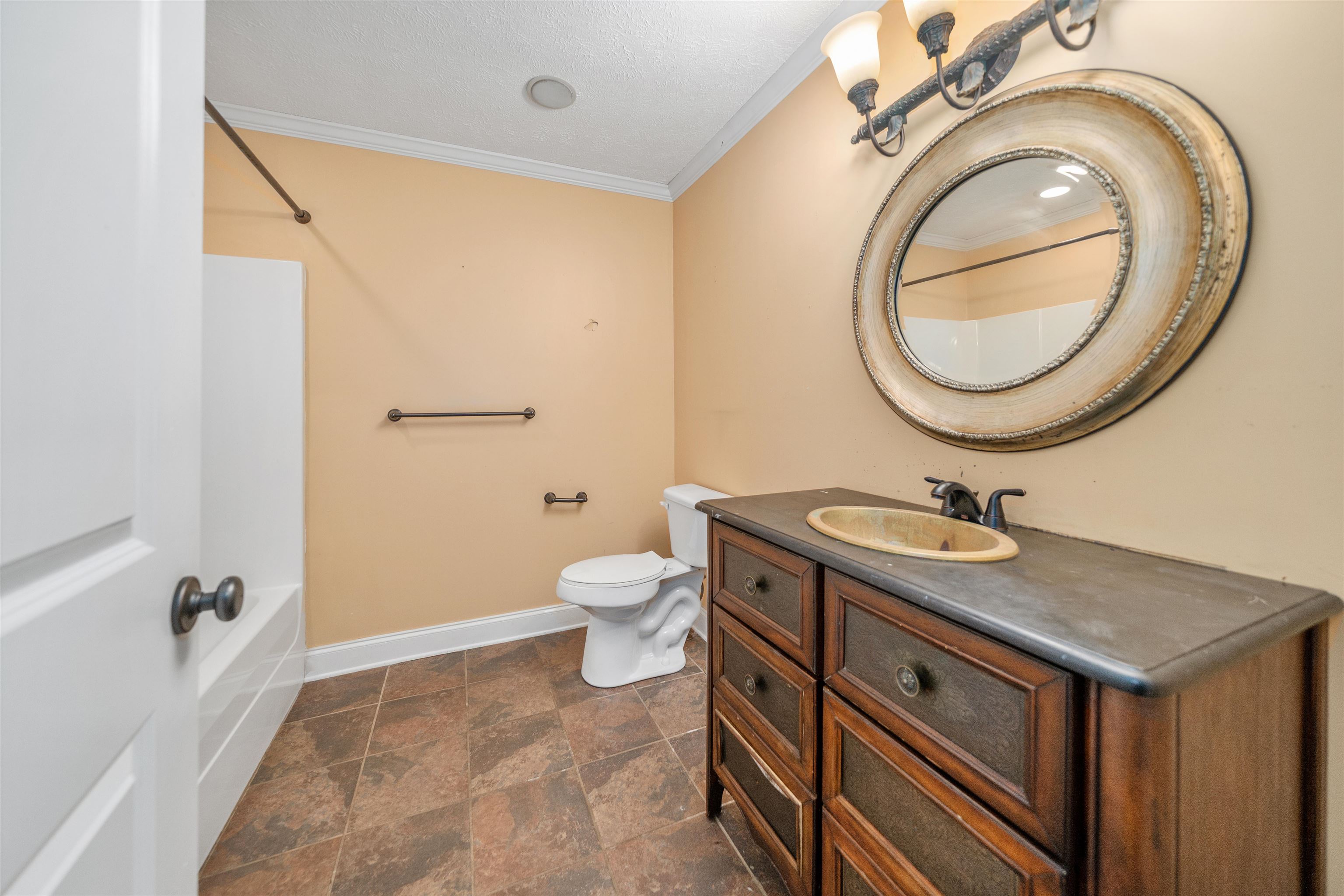 31 Timber Lane Selmer, TN 38375 - Photo 28 of 29 a bathroom with a sink a toilet and a mirror