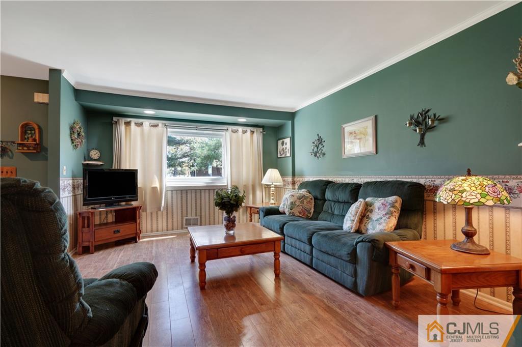 A11 Georges Road Dayton, NJ 08810 - Photo 3 of 25 a living room with fireplace furniture and a flat screen tv