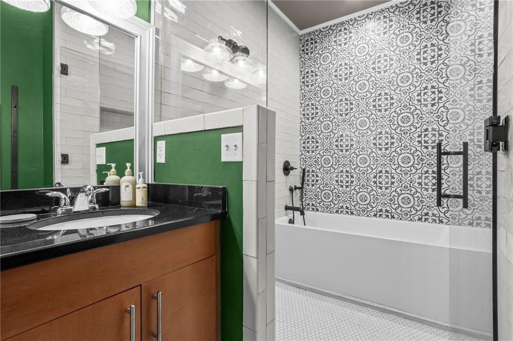 3400 Malone Drive, Unit 219 Atlanta, GA 30341 - Photo 26 of 60 a bathroom with a granite countertop sink a mirror and a shower