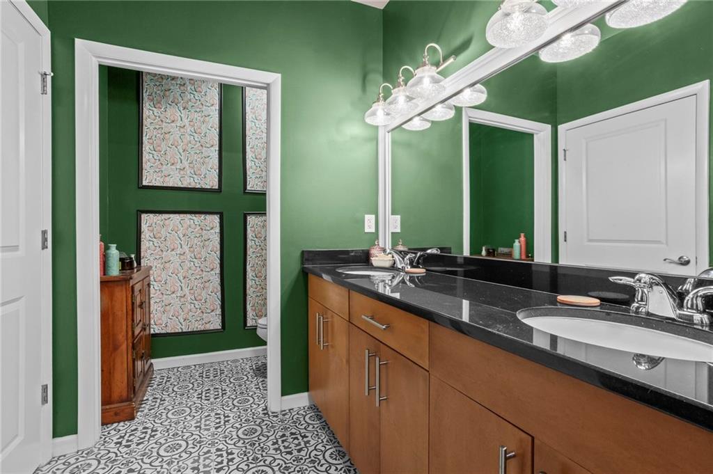3400 Malone Drive, Unit 219 Atlanta, GA 30341 - Photo 29 of 60 a bathroom with a double vanity sink and a mirror