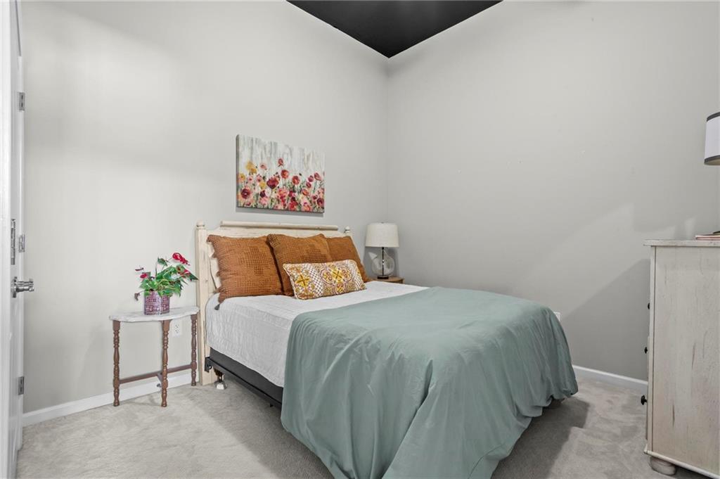 3400 Malone Drive, Unit 219 Atlanta, GA 30341 - Photo 33 of 60 a bedroom with a bed and a painting on the wall