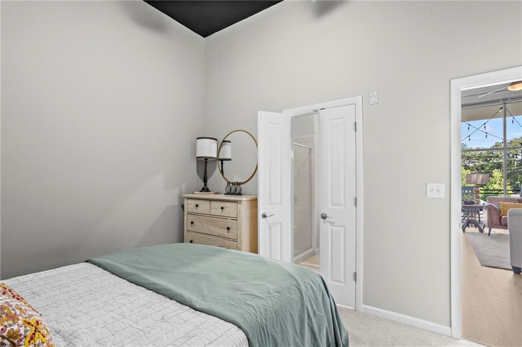 3400 Malone Drive, Unit 219 Atlanta, GA 30341 - Photo 34 of 60 a bedroom with a bed and wooden floor