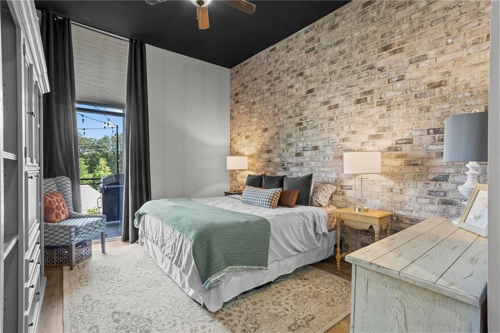 3400 Malone Drive, Unit 219 Atlanta, GA 30341 - Photo 6 of 60 a bedroom with a bed and a fireplace