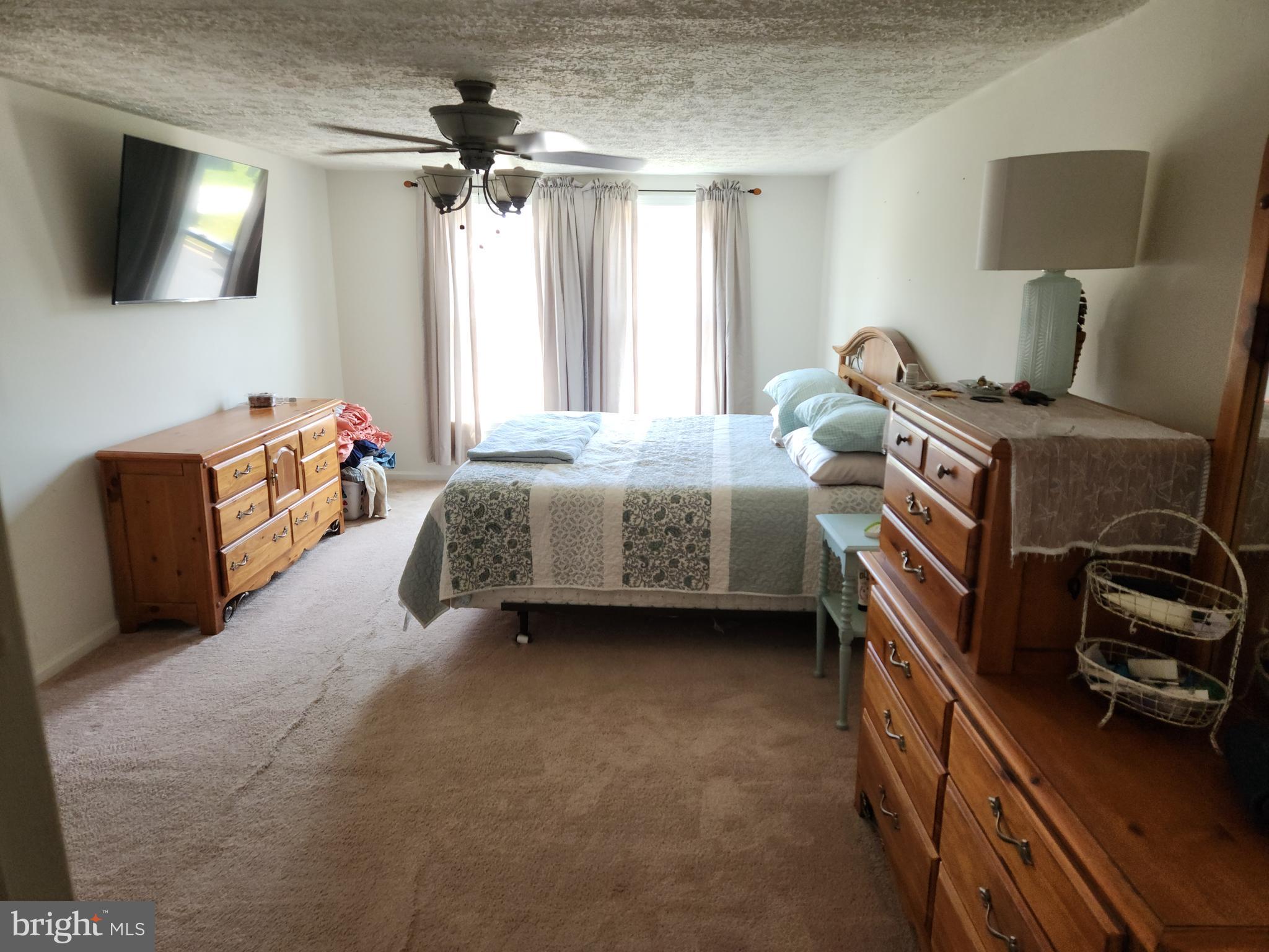1203 Conewago Drive Frederick, MD 21702 - Photo 13 of 24 a bedroom with bed and a flat tv screen on the dresser