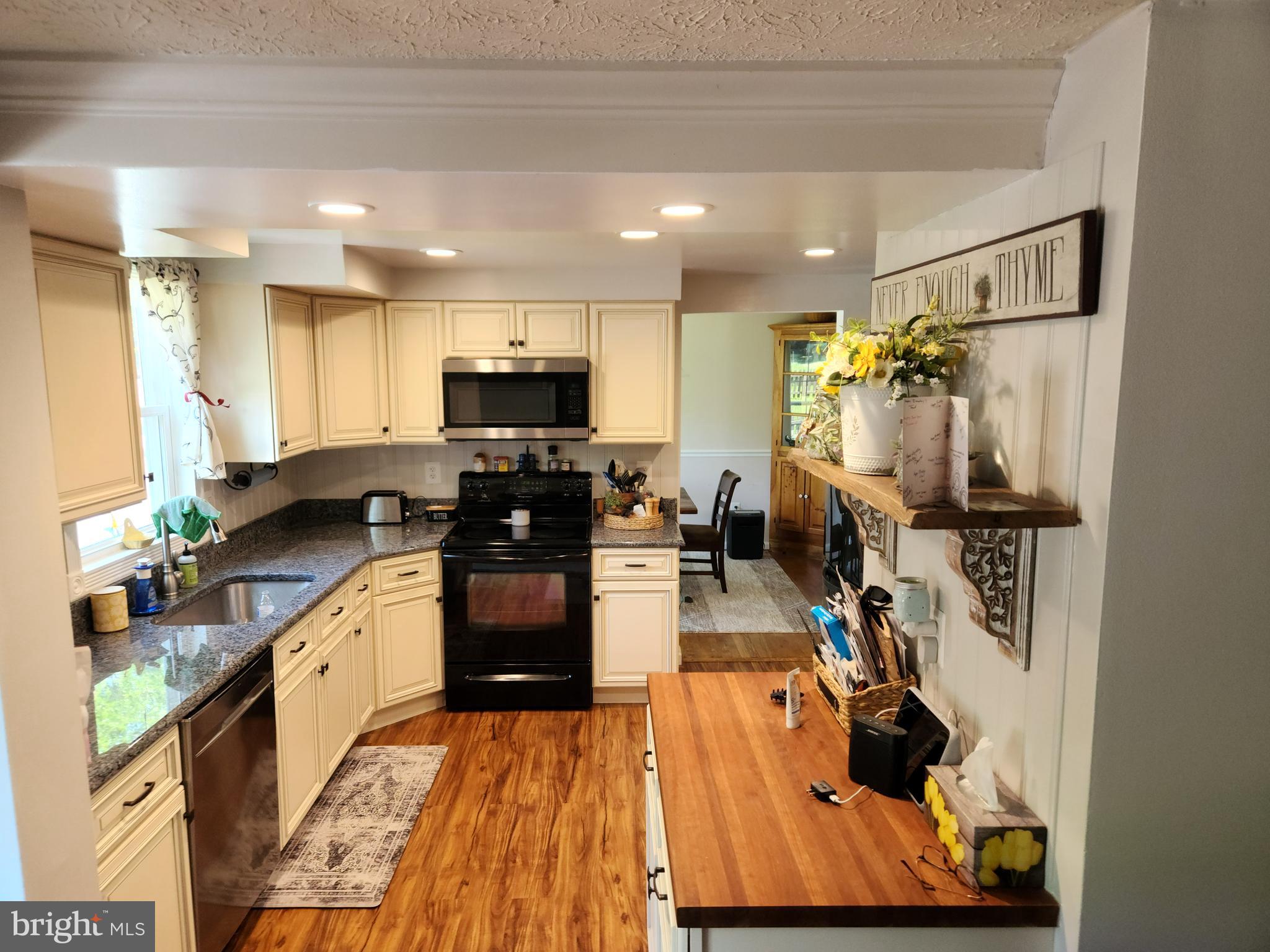 1203 Conewago Drive Frederick, MD 21702 - Photo 4 of 24 a kitchen with refrigerator and microwave