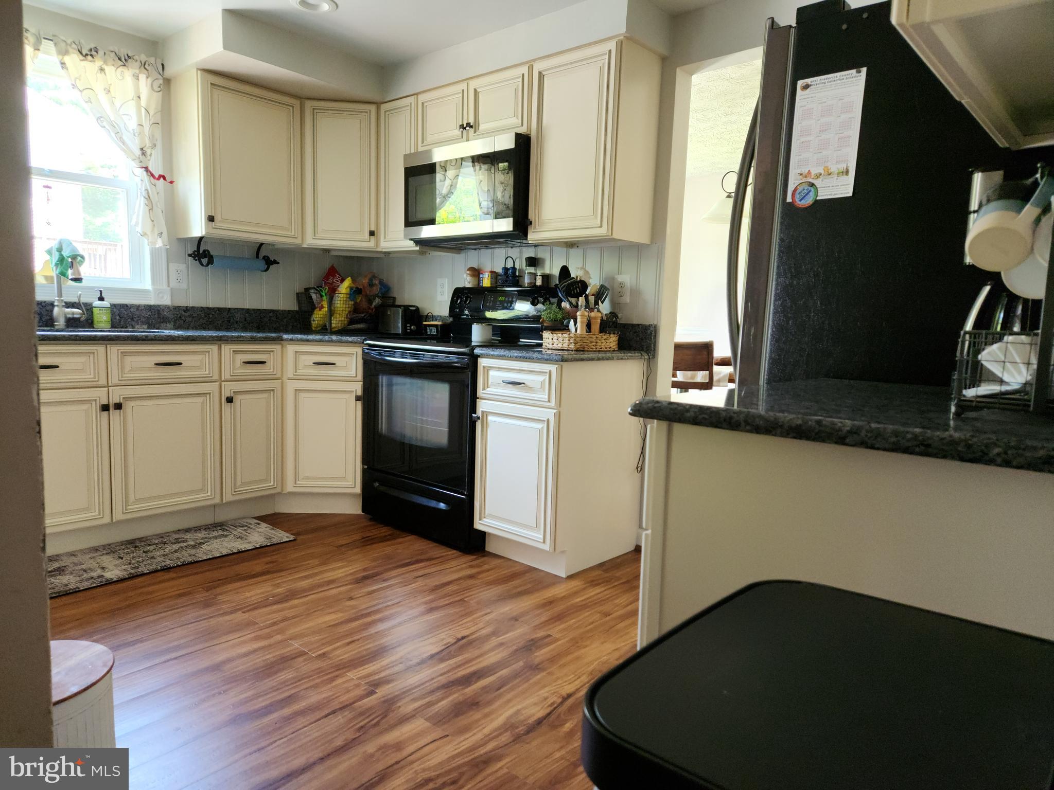 1203 Conewago Drive Frederick, MD 21702 - Photo 6 of 24 a kitchen with a sink appliances and cabinets