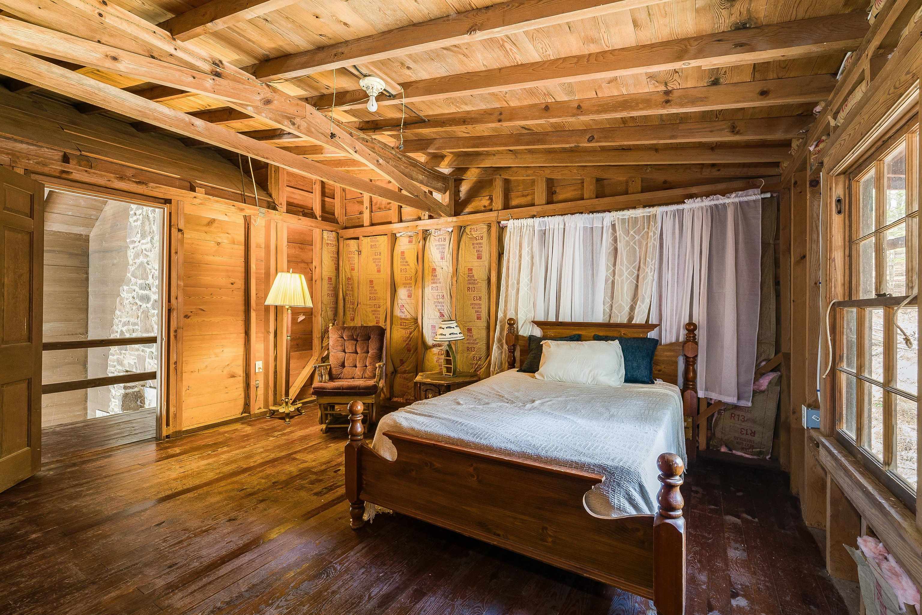 595 Deerfield Valley Road West Augusta, VA 24485 - Photo 57 of 71 a bedroom with a bed and wooden floor