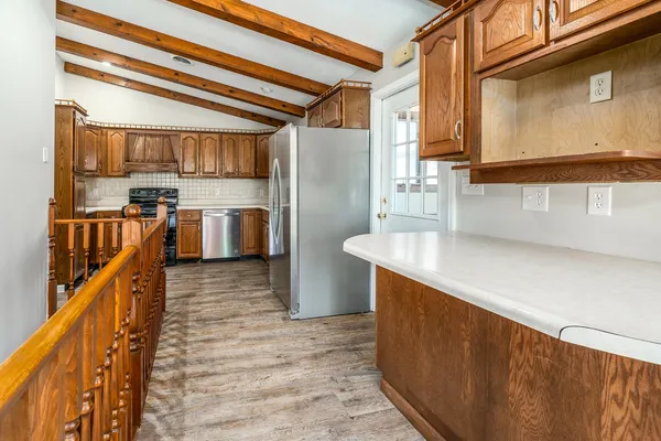 a kitchen with refrigerator and cabinets