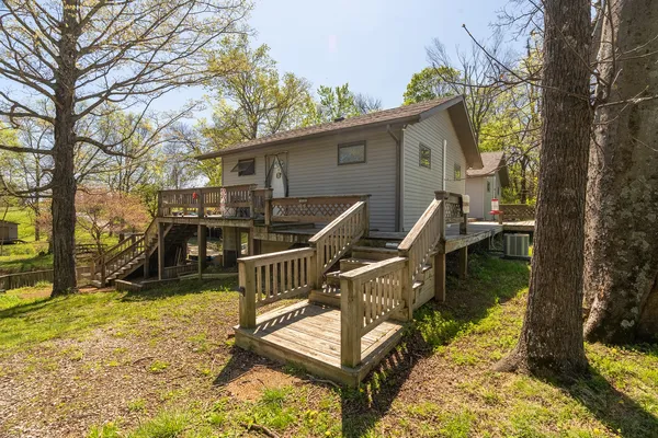 a view of a house with a wooden deck
