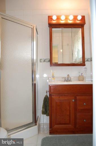 1203 Culvert Road Towson, MD 21286 - Photo 22 of 28 a bathroom with a sink vanity and a mirror