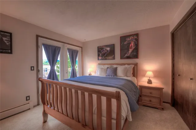 a bedroom with a large bed and a window