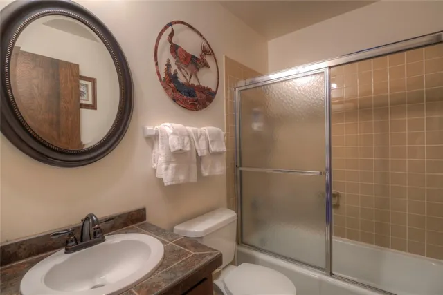 a bathroom with a toilet and a mirror