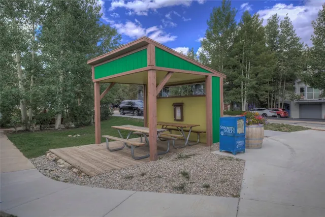 a tennis court that has yard in the back