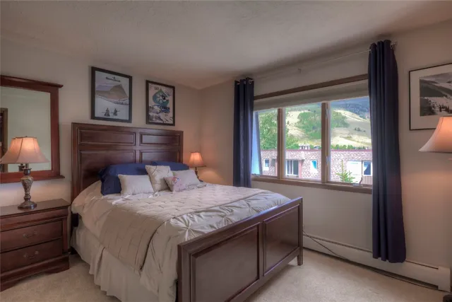 a bedroom with a large bed and a large window