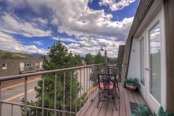 a view of a balcony with wooden floor