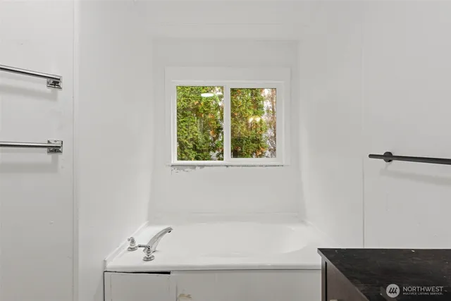 a bathroom with a bathtub and shower