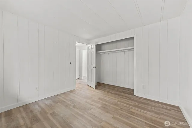 a view of an empty room and wooden floor