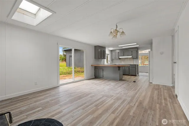 wooden floor fireplace and windows in an empty room